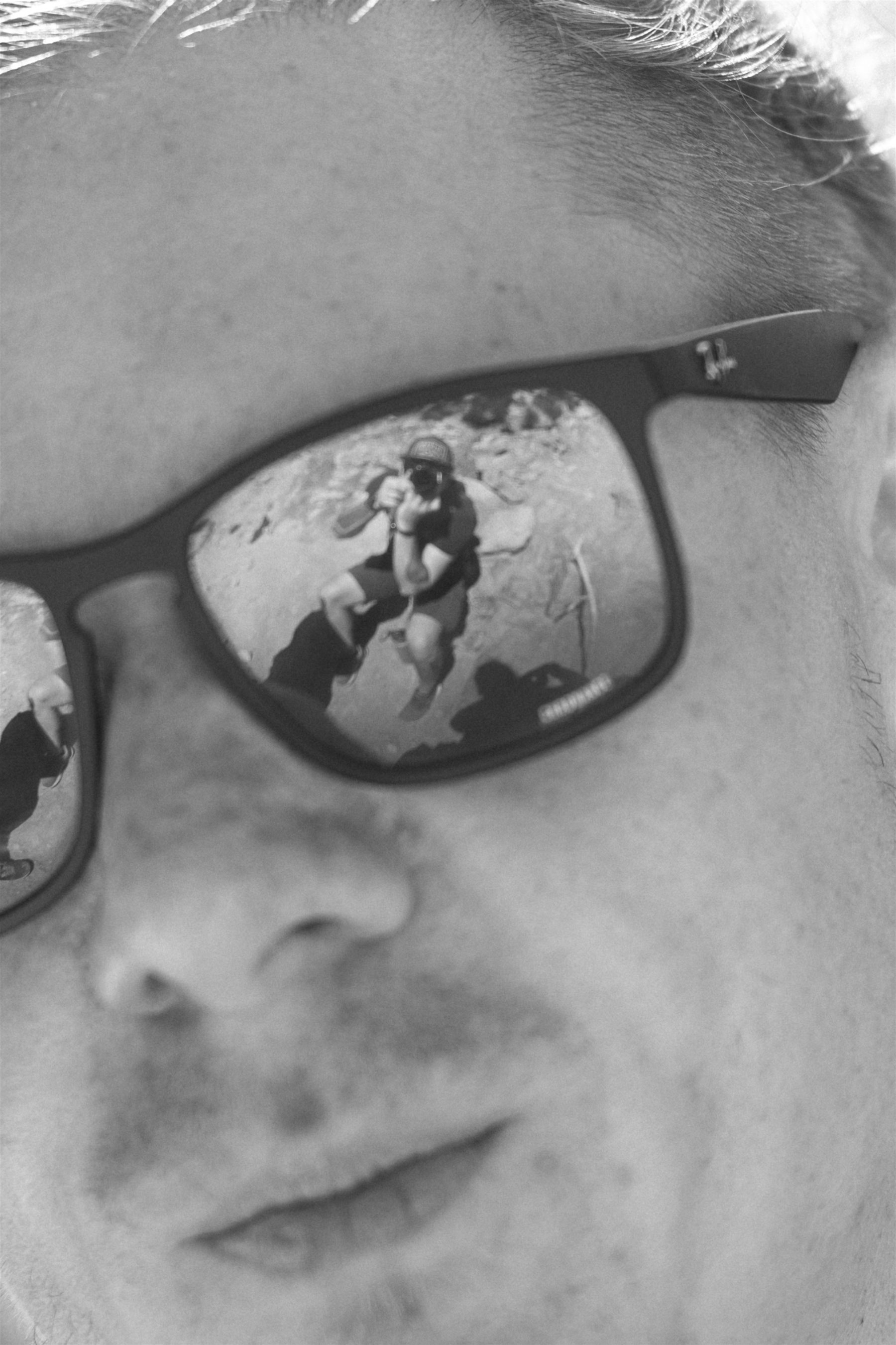 Portrait with Anton Tishkin reflected in a sunglass lens